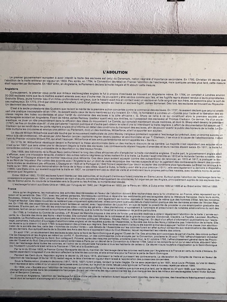 A text panel about the end of slavery hangs in a museum on Goree Island.