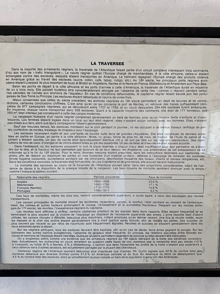 A text panel about the sea crossing of enslaved people hangs in a museum on Goree Island.