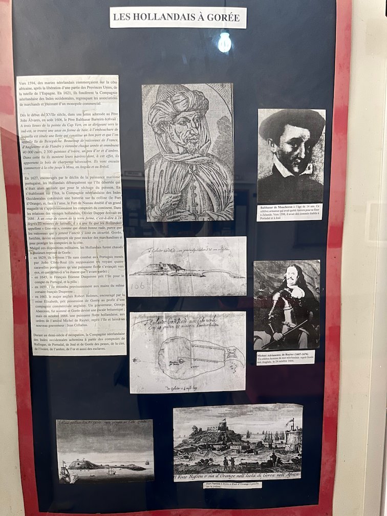 A museum board shows texts and pictures about the Dutch on Goree Island.