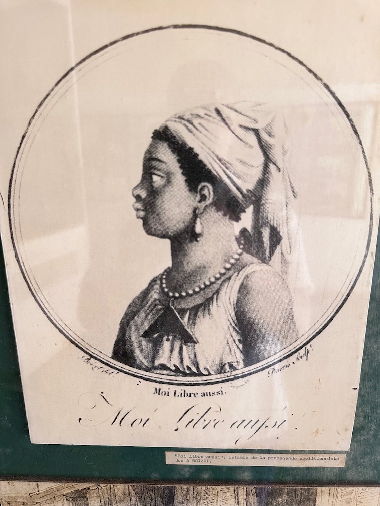An old engraving shows a woman in profile with the words Moi libre aussi.