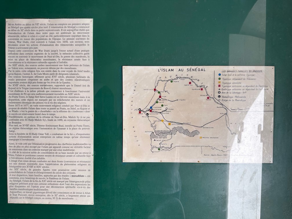 A museum board shows a text and a map about Islam in Senegal.