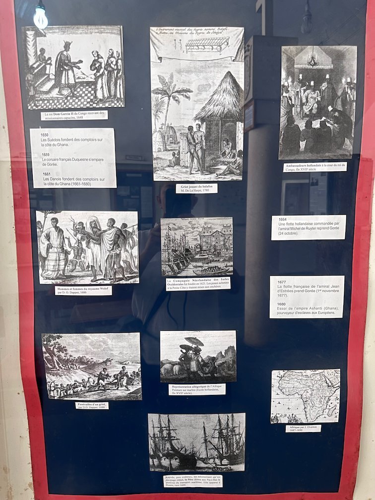 A museum board shows old pictures of the slave trade on Goree Island.