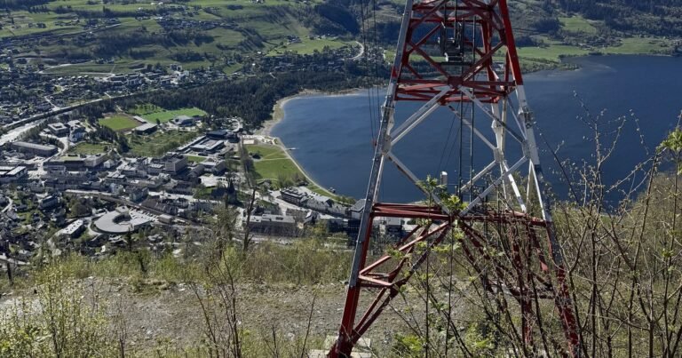 Voss and its lake seen from a hillside below a gondola mast, Vestland, Norway