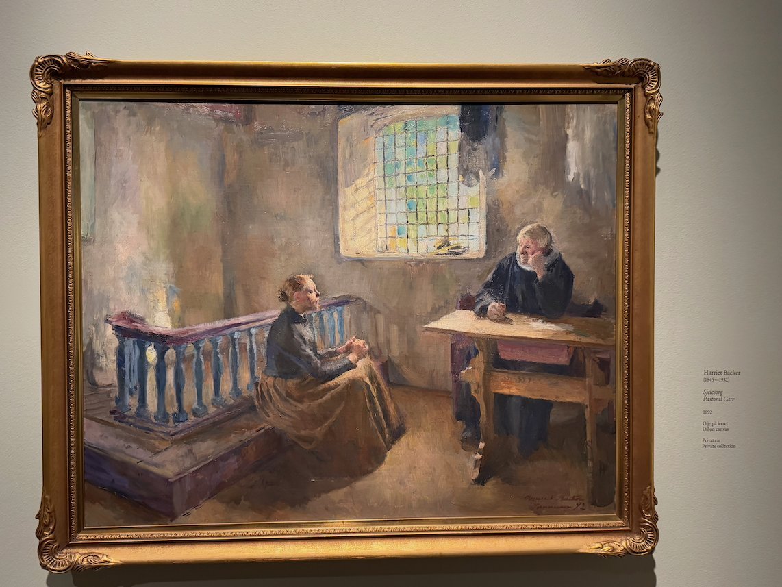 Painting by Harriet Backer of a woman by a wooden balustrade and a man at a desk by a lead glass window