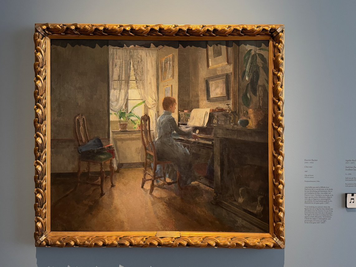 Painting by Harriet Backer of a woman at a piano in a room with a window