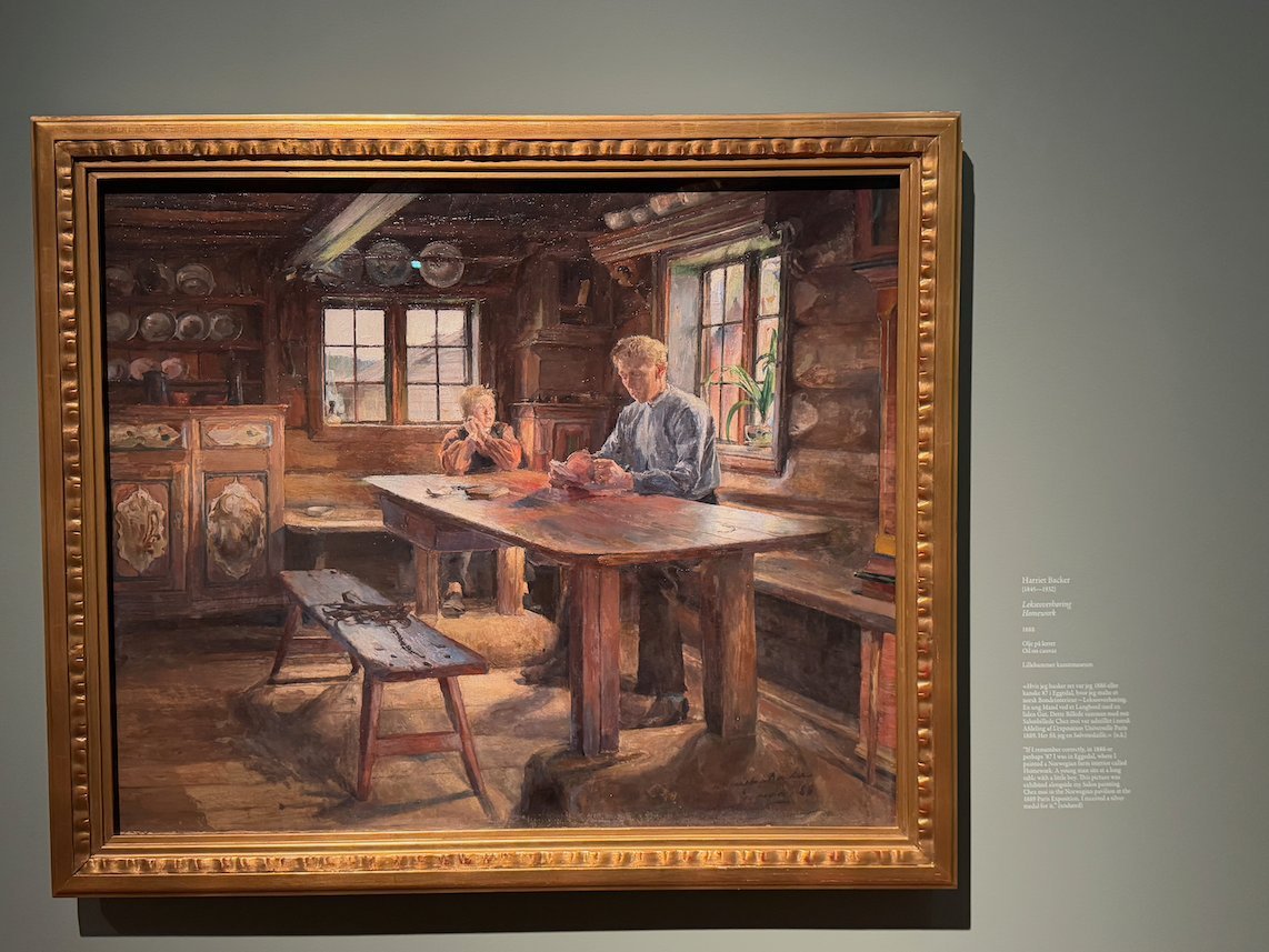 Painting by Harriet Backer of a man and a child at a table in a wooden farmhouse room