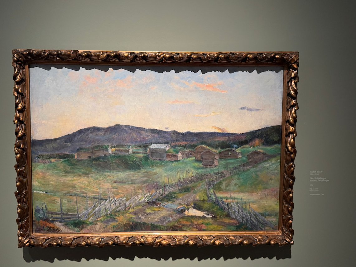 Landscape painting by Harriet Backer of farms and hills in evening light