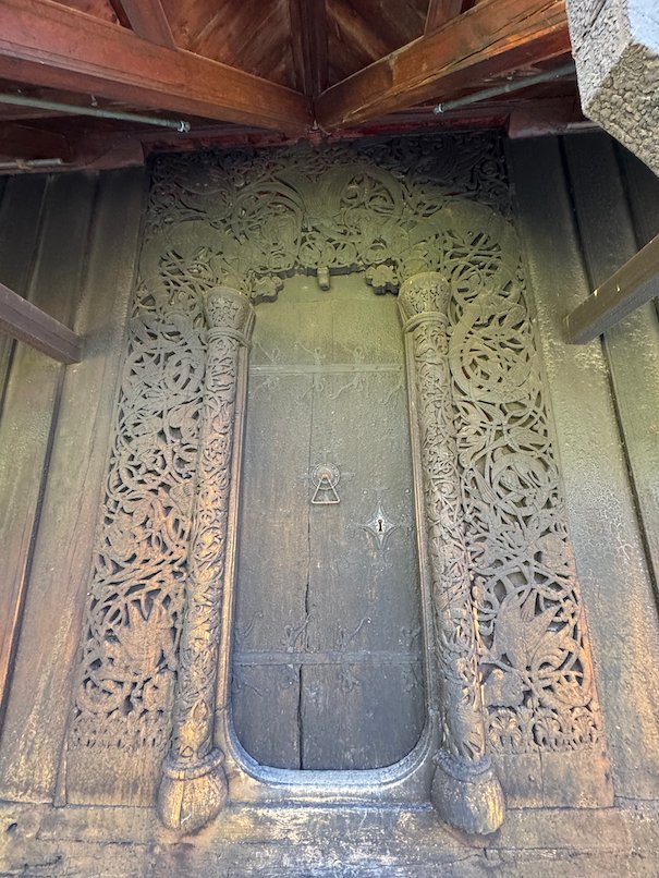 Carved wooden door portal with dragon patterns at Hopperstad stave church