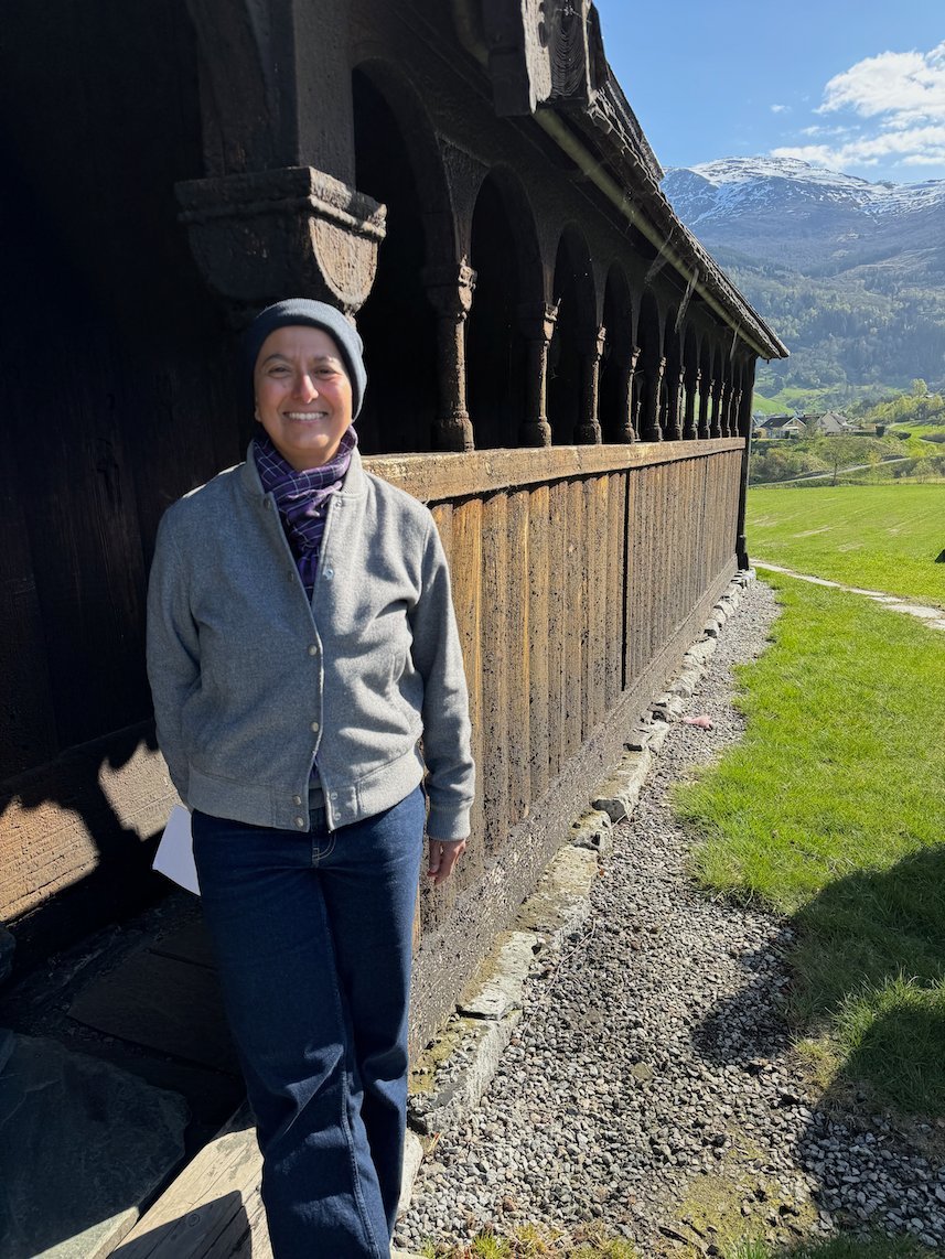 Zayera Khan stands in the covered gallery of Hopperstad stave church