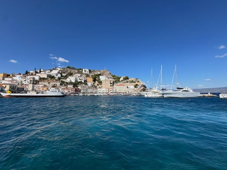 Hydra harbor and town with sailing boats, seen from the sea