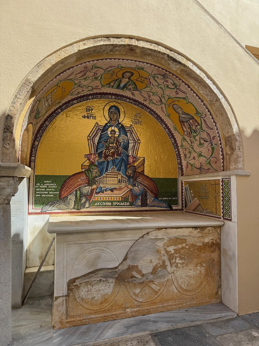 Mosaic of the Virgin and Child above a marble basin in an arched niche in Hydra