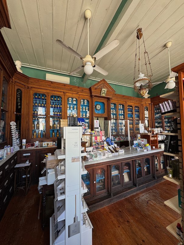 Interior of the old pharmacy in Hydra with wooden shelves and a green ceiling