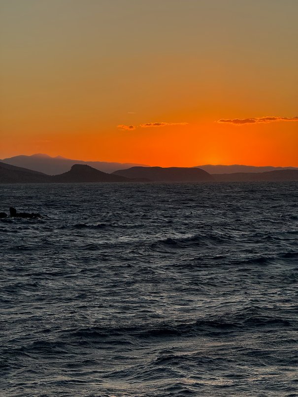 Orange sky and dark sea after sunset at Hydra