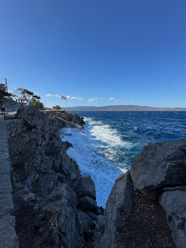 Dark rocks and white waves on the coast of Hydra