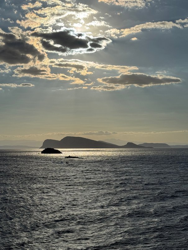 Clouds and light over the sea with a small island near Hydra