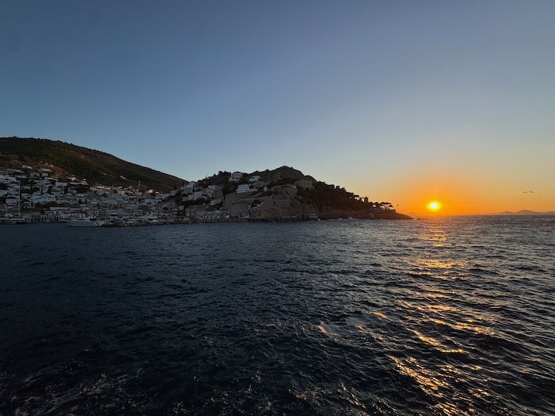 Sunset over the sea with Hydra town on the left