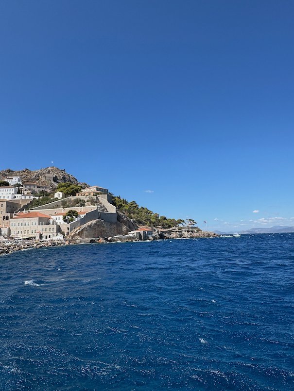 Hydra town and its houses on the hill above the deep blue sea