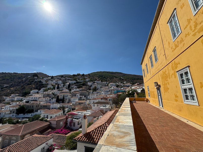 View over Hydra town from the terrace of an ochre yellow mansion
