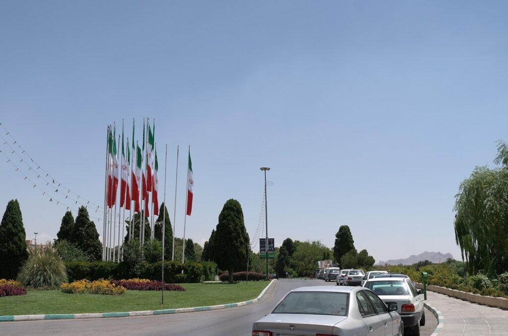 Roundabout with Iranian flags and flower beds in Isfahan
