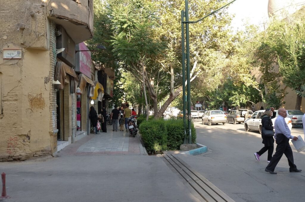 People who walk on a tree-lined street in Isfahan
