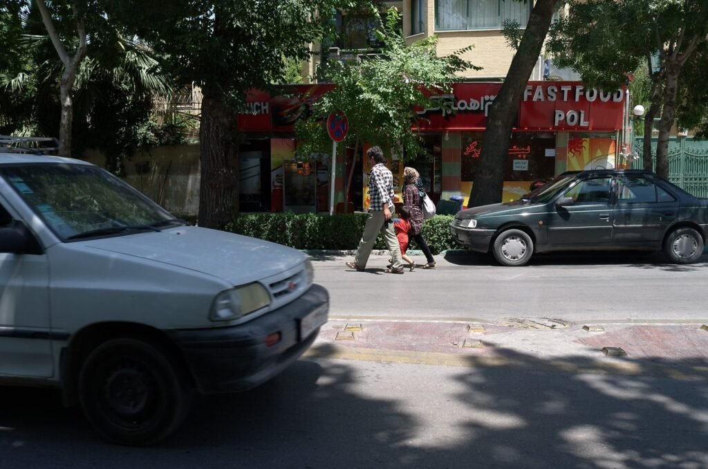 Street with cars and a fast food shop in Isfahan