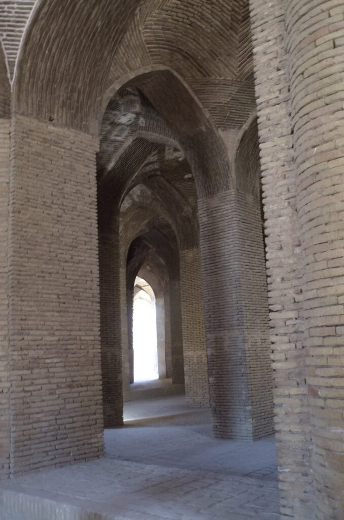 Brick pillars and arches with light in the Jameh Mosque of Isfahan