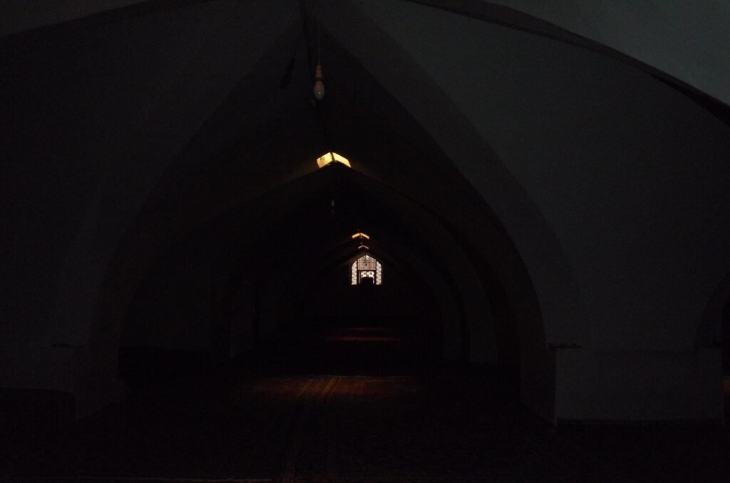 Dark hall with a lamp in the Jameh Mosque of Isfahan