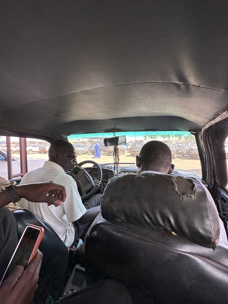 Passengers sit in an old bush taxi on the way to Joal-Fadiouth.