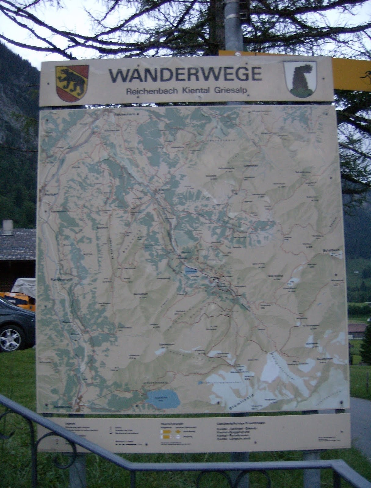 A map board shows the hiking trails of Reichenbach and Kiental in Switzerland.