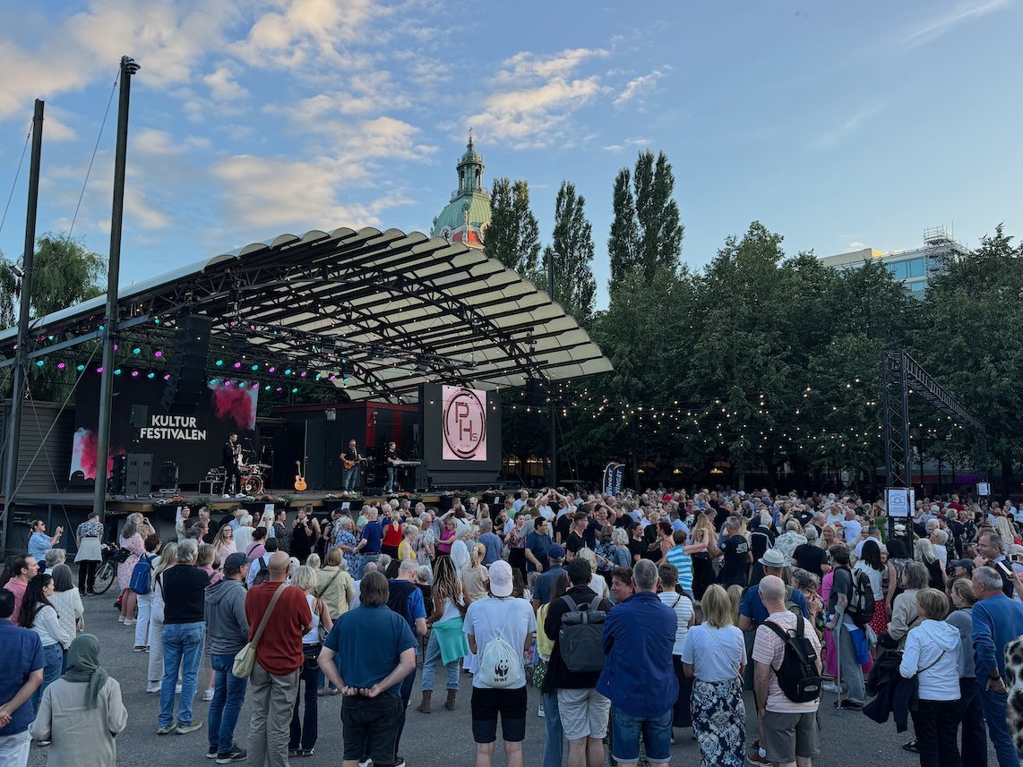 A large audience in front of a Kulturfestivalen stage on a summer evening in central Stockholm