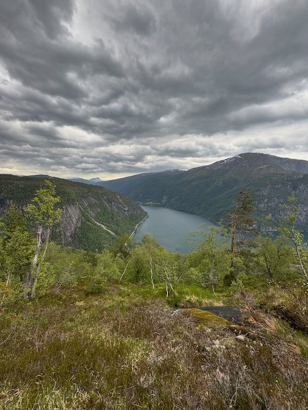 The Hardangerfjord between hills under heavy grey clouds