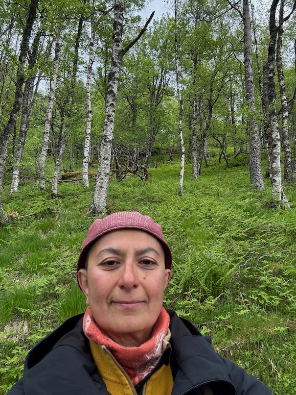 Selfie in a red hat and scarf in the birch forest on the Kvanndal trail