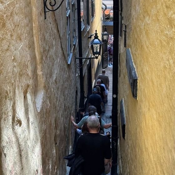Visitors walk through Märten Trotzigs Gränd, the narrowest alley in Gamla Stan, Stockholm's old town, photographed by Zayera Khan