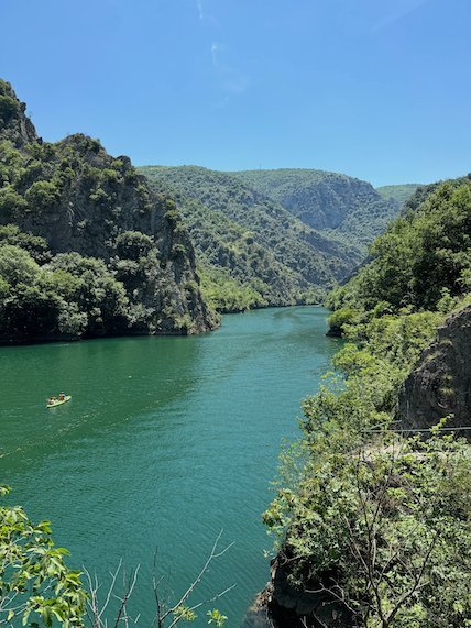 A green lake winds between wooded hills in Matka Canyon near Skopje.