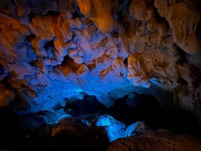 Blue and orange lights shine on stalactites inside Vrelo Cave at Matka near Skopje.