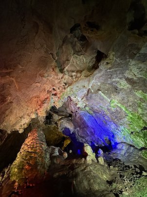 Coloured lights shine on tall rock formations inside Vrelo Cave at Matka near Skopje.