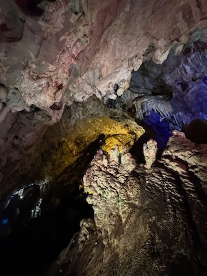 Yellow and purple lights show rock columns inside Vrelo Cave at Matka near Skopje.