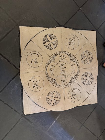 Round marble floor plate with Greek letters and crosses in a Meteora monastery