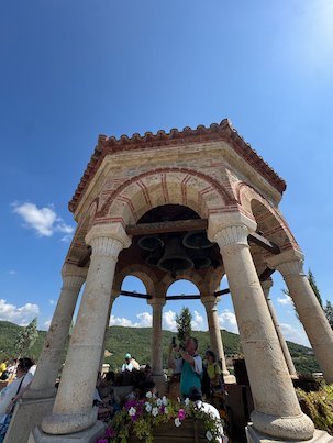 Round bell pavilion with columns and bells at a Meteora monastery