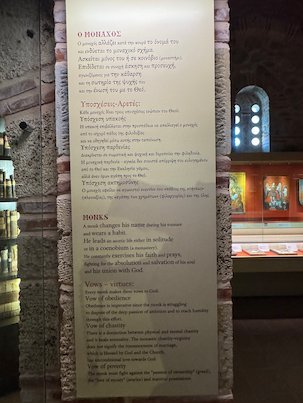 Museum panel about monks in Greek and English in a Meteora monastery