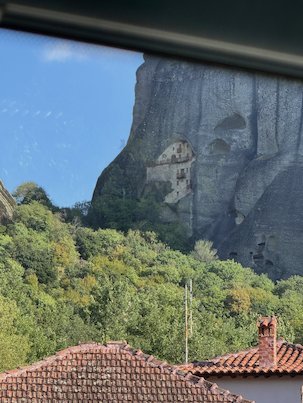 Huge rock face seen through the bus window at Meteora