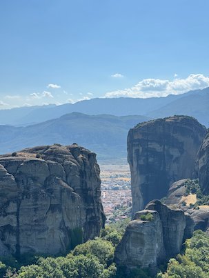 Two big rock towers at Meteora with the town far below