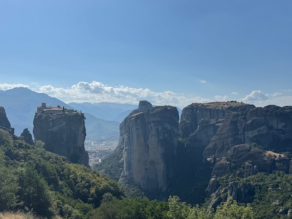 Panorama of the Meteora rock towers with a monastery on the left