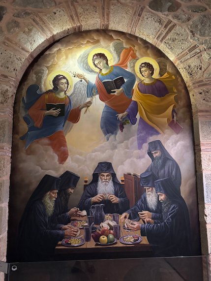 Wall painting of angels above monks at a table in a Meteora monastery