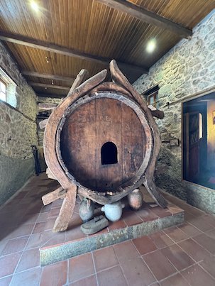 Front of the giant wooden wine barrel with a small door in a Meteora monastery