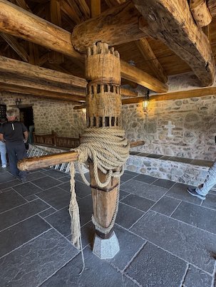 Old wooden winch with thick ropes, once used to lift goods and people up to the monastery