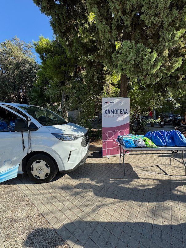 Mobile laundry van and a table with supplies for unhoused people in Athens