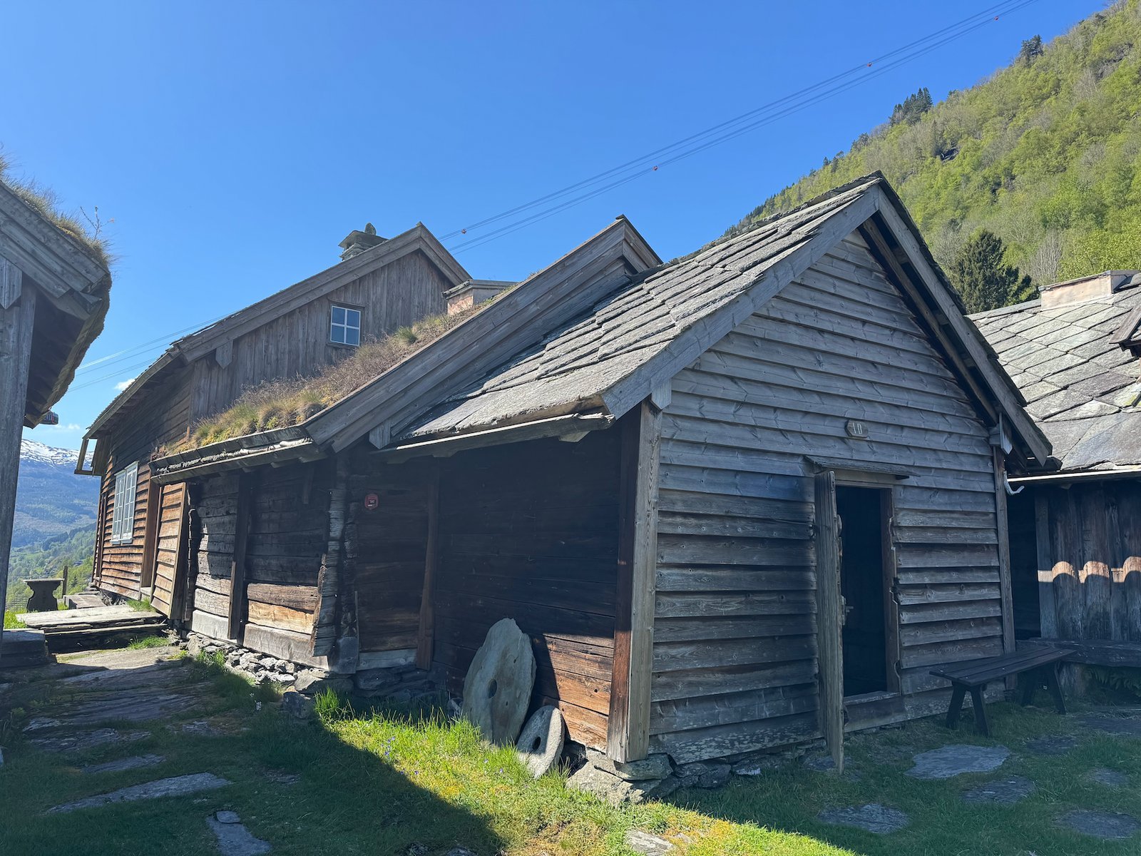 Row of old wooden farm buildings with grass roofs at Mølstertunet in Voss