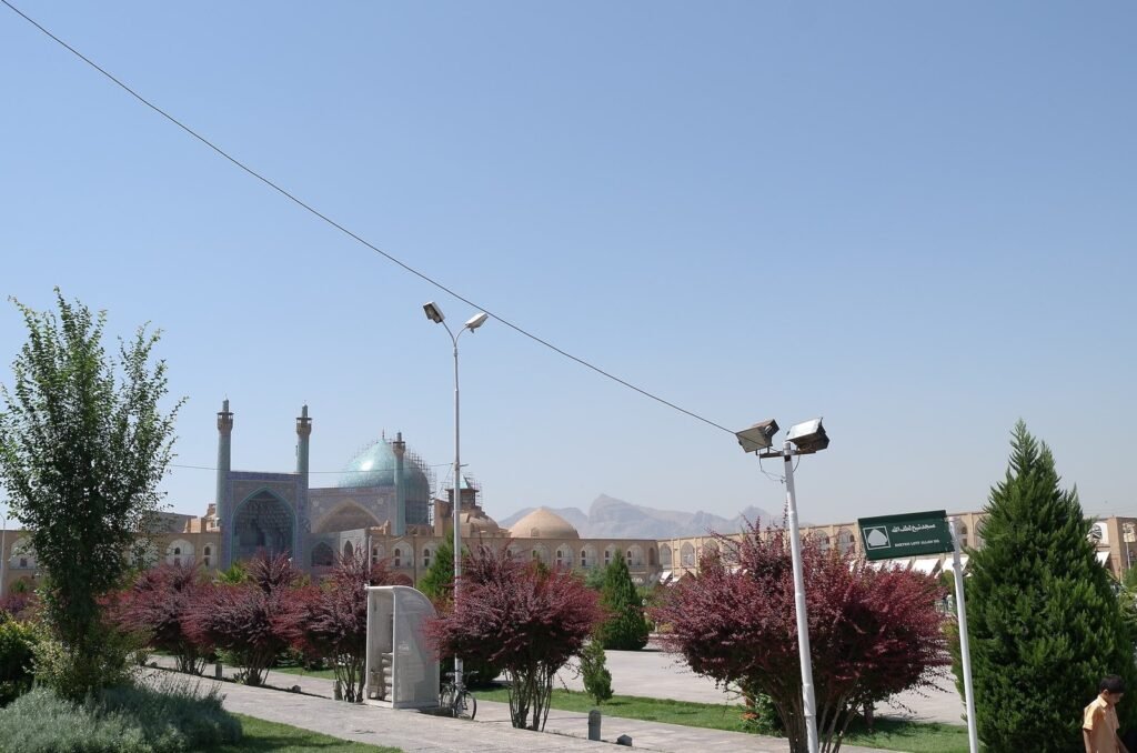 Trees and flower beds on Naqsh-e Jahan Square with the Shah Mosque behind