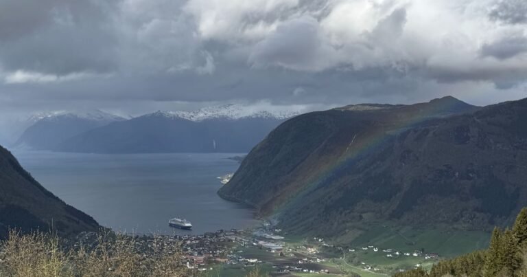 Rainbow over a fjord between steep mountains in western Norway